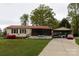 Charming single-story home with a red roof, a well-maintained lawn, and a convenient carport at 115 Setter Ct, Statesville, NC 28625