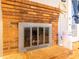 Close-up of the brick fireplace with a metal screen and hearth in the living room area at 115 Setter Ct, Statesville, NC 28625