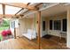 Inviting front porch with a wooden swing, string lights, and covered roof at 115 Setter Ct, Statesville, NC 28625