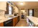 Bright kitchen features marble countertops, white upper cabinets and wooden lower cabinets with stainless steel appliances at 115 Setter Ct, Statesville, NC 28625
