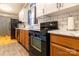 Bright kitchen features wooden lower cabinets and marble countertops with stainless steel appliances at 115 Setter Ct, Statesville, NC 28625