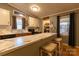Bright kitchen features an island with marble countertops, white upper cabinets and wooden lower cabinets at 115 Setter Ct, Statesville, NC 28625