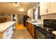 Bright kitchen features an island with marble countertops, white upper cabinets and wooden lower cabinets at 115 Setter Ct, Statesville, NC 28625