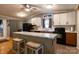 Bright kitchen features an island with marble countertops, white upper cabinets and wooden lower cabinets at 115 Setter Ct, Statesville, NC 28625