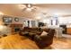 Comfortable living area featuring a brick fireplace, wood floors, and open access to the kitchen at 115 Setter Ct, Statesville, NC 28625