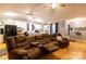 Open-concept living space with hardwood floors, a comfortable sofa, and a view into the kitchen at 115 Setter Ct, Statesville, NC 28625