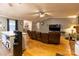Open concept living room with hardwood floors, view into the kitchen, and a brick fireplace at 115 Setter Ct, Statesville, NC 28625