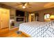 Comfortable main bedroom with wood flooring, a ceiling fan, and neutral-colored walls and attached bathroom at 115 Setter Ct, Statesville, NC 28625
