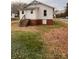 Exterior shot of the back of a house with stairs leading to the door and red brick foundation at 120 3Rd Ave, Conover, NC 28613