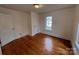 This bedroom is bright, featuring hardwood floors and a large window at 120 3Rd Ave, Conover, NC 28613