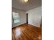 Bright bedroom featuring a large window and hardwood floors at 120 3Rd Ave, Conover, NC 28613