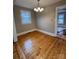 Bright dining area features an elegant light fixture, a window, and hardwood floors at 120 3Rd Ave, Conover, NC 28613