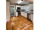 Fully-equipped kitchen boasts modern appliances, white cabinets, and a subway tile backsplash and wood flooring at 120 3Rd Ave, Conover, NC 28613