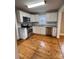 Modern kitchen with stainless steel appliances, white cabinets and tiled backsplash, and wood flooring at 120 3Rd Ave, Conover, NC 28613