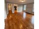 Bright living room featuring wood floors, natural light, and access to other areas of the home at 120 3Rd Ave, Conover, NC 28613