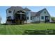 A white house with a screened in porch sits on a beautifully manicured lawn at 129 Ryleigh Dan Pl, Mooresville, NC 28115