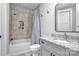 Bathroom with a shower over tub with a decorative shower curtain, with single granite vanity at 129 Ryleigh Dan Pl, Mooresville, NC 28115