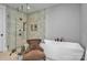Bright bathroom featuring a glass walk-in shower, soaking tub, and modern fixtures at 129 Ryleigh Dan Pl, Mooresville, NC 28115