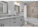 Bathroom featuring double vanity with granite countertop, tub with tiled shower, and linen closet at 129 Ryleigh Dan Pl, Mooresville, NC 28115