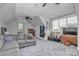 A large bedroom with a sitting area, dresser, and electric instruments at 129 Ryleigh Dan Pl, Mooresville, NC 28115