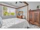 Sun-filled bedroom with a four-poster bed, large window, and traditional wood wardrobe at 129 Ryleigh Dan Pl, Mooresville, NC 28115