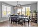 Dining room features a large window, modern light fixture, and seating for six at 129 Ryleigh Dan Pl, Mooresville, NC 28115