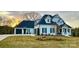Attractive two-story home with an attached garage, featuring a well-maintained lawn and tasteful landscaping at 129 Ryleigh Dan Pl, Mooresville, NC 28115