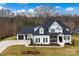 Stunning two-story home featuring a modern farmhouse design with a well-manicured lawn and black shutters at 129 Ryleigh Dan Pl, Mooresville, NC 28115