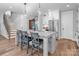 Kitchen island with granite countertop, bar stool seating and stainless-steel appliances at 129 Ryleigh Dan Pl, Mooresville, NC 28115