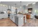 Open-concept kitchen featuring a large center island, stainless steel appliances, and hardwood flooring at 129 Ryleigh Dan Pl, Mooresville, NC 28115