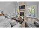 Bright living room boasts a brick fireplace, large windows and hardwood floors at 129 Ryleigh Dan Pl, Mooresville, NC 28115
