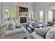 Cozy living room with brick fireplace, large windows and comfortable seating at 129 Ryleigh Dan Pl, Mooresville, NC 28115