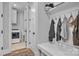 Mud room with a utility sink, washer/dryer, storage shelf, and coat hooks at 129 Ryleigh Dan Pl, Mooresville, NC 28115