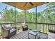 Relaxing screened-in porch with comfortable seating, ideal for enjoying the outdoors in comfort at 129 Ryleigh Dan Pl, Mooresville, NC 28115