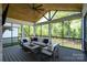 A cozy screened porch features wood ceilings, comfortable seating, and scenic views at 129 Ryleigh Dan Pl, Mooresville, NC 28115