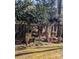 Fenced backyard with mature trees, flowering shrubs, and a charming decorative birdhouse at 140 Rustic Way Ln, Mooresville, NC 28117
