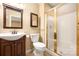 Well-lit bathroom featuring dark wood vanity, a white toilet, and a glass-enclosed shower at 140 Rustic Way Ln, Mooresville, NC 28117