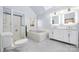 Modern bathroom featuring a double sink vanity, separate shower and soaking tub under a skylight at 140 Rustic Way Ln, Mooresville, NC 28117