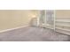 Empty bedroom featuring neutral walls and light-colored carpet with built-in shelving at 140 Rustic Way Ln, Mooresville, NC 28117