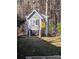 Charming backyard chicken coop with a 'Slow Chickens at Play' sign in a wooded setting at 140 Rustic Way Ln, Mooresville, NC 28117