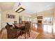 Spacious dining area featuring hardwood floors, vaulted ceiling, and view to the living room at 140 Rustic Way Ln, Mooresville, NC 28117