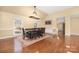 Formal dining room features a large table, elegant chandelier, and bright windows at 140 Rustic Way Ln, Mooresville, NC 28117