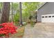 A charming home exterior with colorful azaleas lining a long driveway leading to an attached garage at 140 Rustic Way Ln, Mooresville, NC 28117