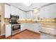 Well-lit kitchen boasts stainless steel appliances, granite countertops, and ample cabinet space at 140 Rustic Way Ln, Mooresville, NC 28117