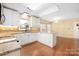 Bright kitchen with granite counters, white cabinets, and hardwood floors at 140 Rustic Way Ln, Mooresville, NC 28117