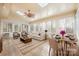 Sunroom with large windows, comfortable seating, and access to a dining area with a table at 140 Rustic Way Ln, Mooresville, NC 28117