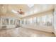 Bright sunroom featuring light-colored wood floors, beadboard paneling, skylights, and multiple windows at 140 Rustic Way Ln, Mooresville, NC 28117