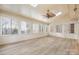 Bright sunroom featuring light-colored wood floors, beadboard paneling, skylights, and multiple windows at 140 Rustic Way Ln, Mooresville, NC 28117
