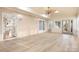 Bright sunroom featuring light-colored wood floors, beadboard paneling, skylights, and multiple windows at 140 Rustic Way Ln, Mooresville, NC 28117