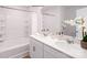 This bathroom features double sinks and a tub with white tile surround at 1416 6Th Ne St, Hickory, NC 28601